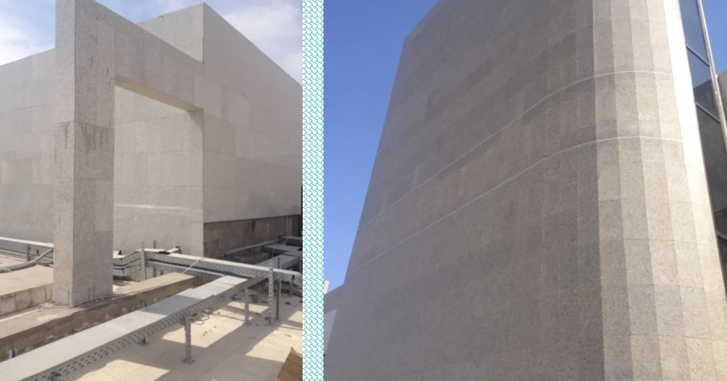Joined views of speckled grey stone cladding: a portal-framed wall with a cable tray in front, and a tall tapered tower face.